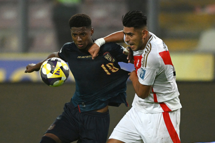 Nilson Angulo battles for the ball against Peru's Carlos Zambrano