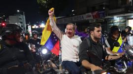 AME3436. CARACAS (VENEZUELA), 08/02/2026.- El opositor Juan Pablo Guanipa (c) sostiene una bandera de Venezuela en una manifestación este domingo, en Caracas (Venezuela). Una caravana de motocicletas y automóviles partió desde el oeste de Caracas hacia varias cárceles, una actividad en apoyo a familiares de presos políticos y encabezada por los opositores Juan Pablo Guanipa y Jesús Armas, excarcelados horas antes. EFE/ Ronald Peña R