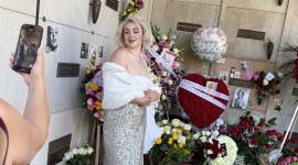 A woman dressed as Marilyn Monroe poses in front of her crypt in the Corridor of Memories mausoleum at Pierce Brothers Westwood Village Memorial Park & Mortuary in Los Angeles on June 1, 2026, on the 100th anniversary of the icons birth. Marilyn Monroe's hometown of Hollywood kicks off June 1 a series of special events marking the 100th anniversary of the movie icon's birth. At the historic Chinese Theatre, where Monroe's handprints are immortalized alongside "Gentlemen Prefer Blondes" (1953) co-star Jane Russell, fans plan to sing "Happy Birthday" -- echoing her famed sultry serenade to president John F. Kennedy. One hundred roses and a cake will be placed at the site, a symbol of Hollywood's golden age and a popular tourist hotspot. (Photo by Chris DELMAS / AFP)