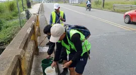 Jóvenes realizan tareas de limpieza en una carretera como parte del programa Jóvenes en Acción.