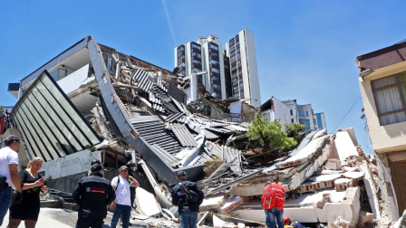 Varias personas permanecen cerca de un edificio derrumbado tras un terremoto en Manizales, Colombia, el 10 de agosto de 2026.