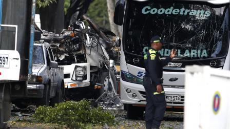 Integrantes de la Policía Nacional inspeccionan la zona del atentado tras una explosión en inmediaciones de la Escuela Militar de Aviación Marco Fidel Suárez en Cali (Colombia).